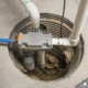 Close up of a sump pump installed in a home basement for domestic plumbing use