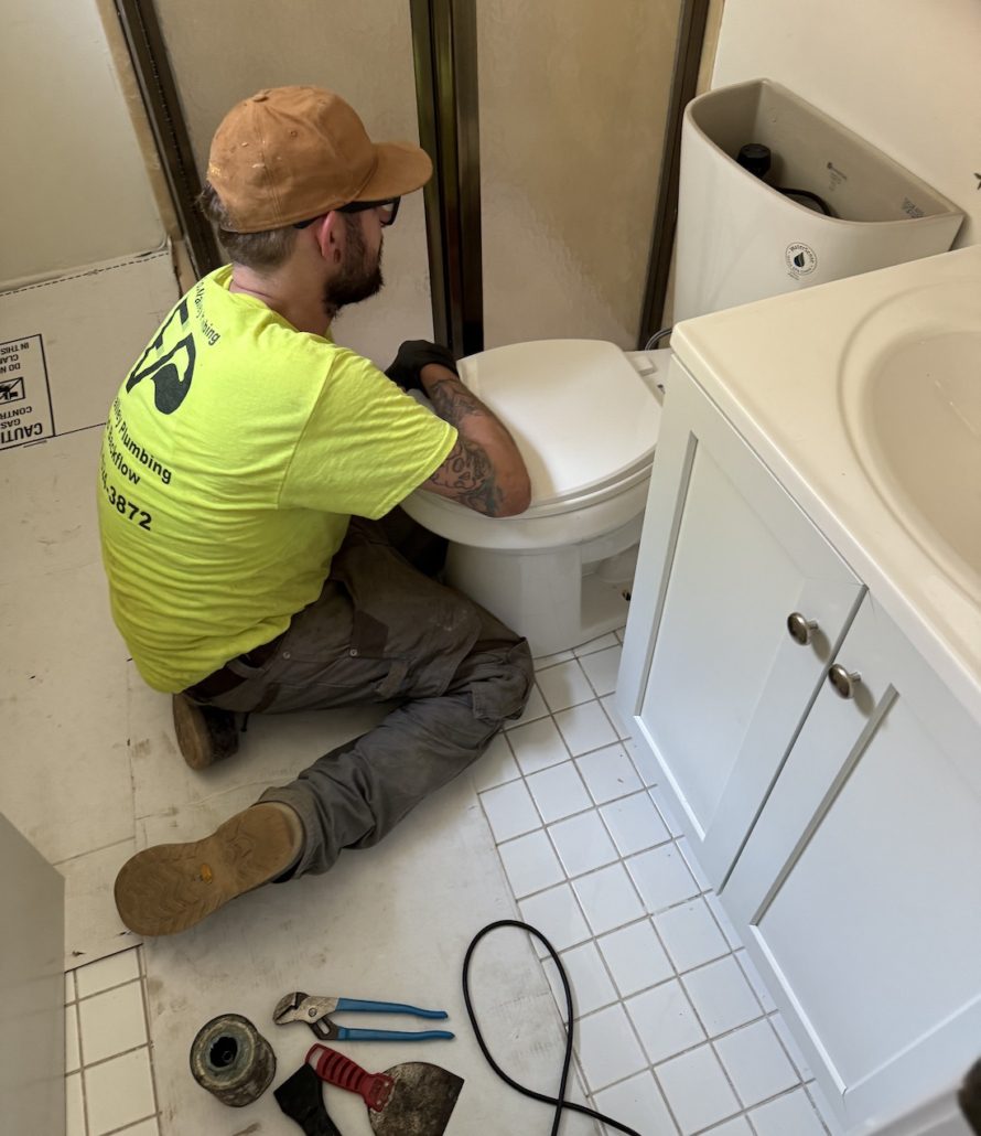 Fox Valley Plumbing technician installing a new toilet in Elgin IL bathroom