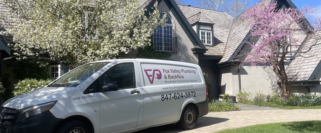 Plumber performing drain cleaning service in Elgin IL kitchen
