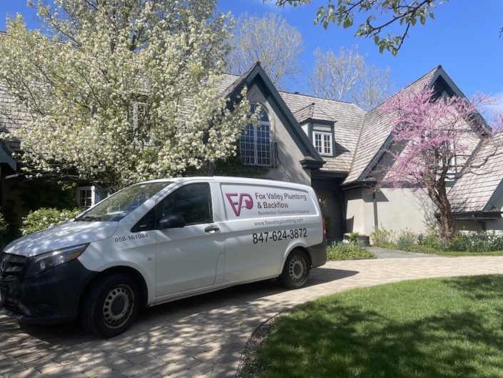 Elgin IL Drain Cleaning — Fox Valley Plumbing Expert Tips Plumber performing drain cleaning service in Elgin IL kitchen
