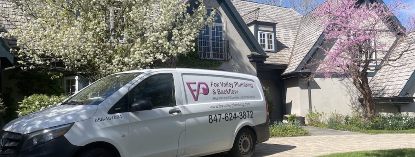 Plumber performing drain cleaning service in Elgin IL kitchen