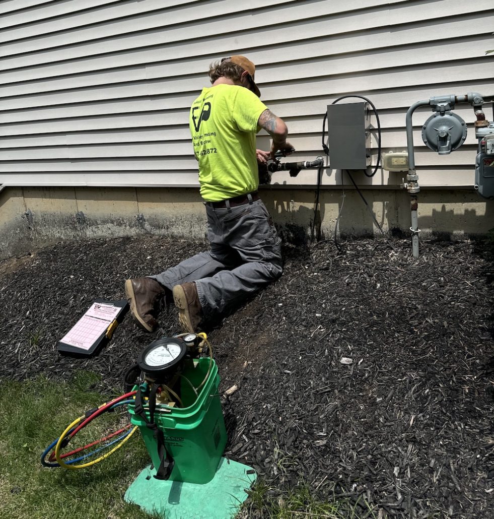 Homeowner locating main water shutoff valve during plumbing emergency in Elgin IL
