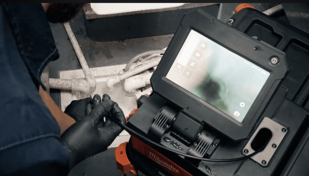 Video sewer inspection camera being used on a main sewer line in Elgin IL