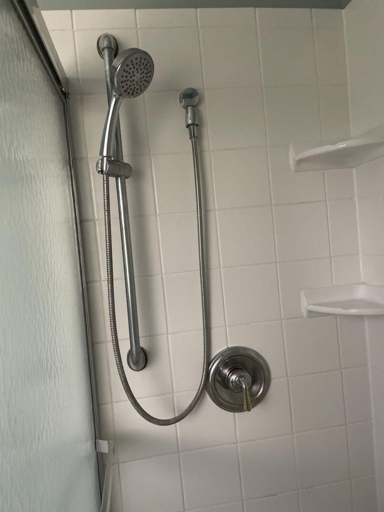 Elgin homeowner safely replacing a toilet flapper as a DIY plumbing task