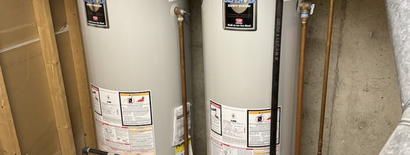 Plumber inspecting a water heater in an Elgin IL home before the holiday season